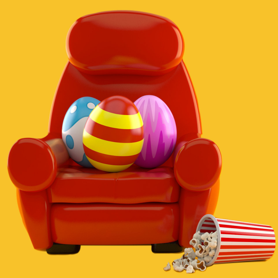 red movie chair filled with large Easter eggs, and large popcorn bucket spilled on the floor