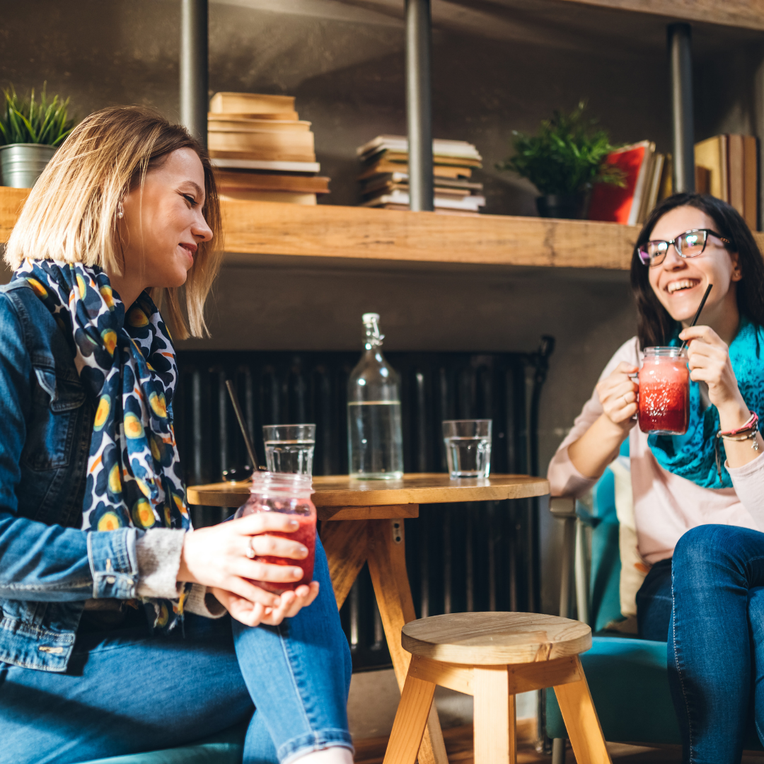 2 women talking over drinks