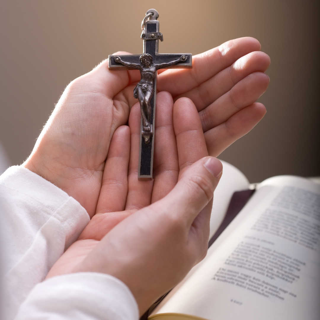 handheld cross and Bible
