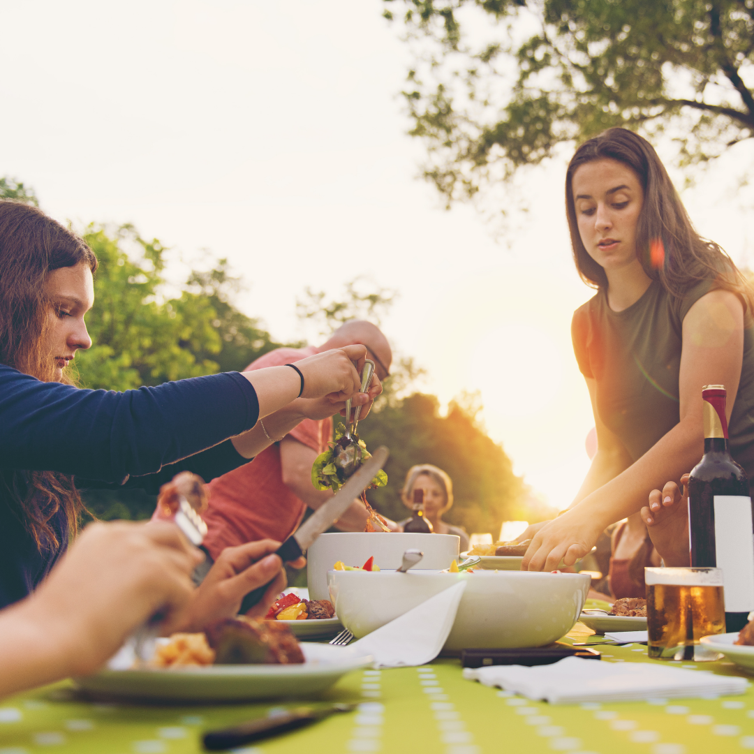 family enjoying a picnic dinner