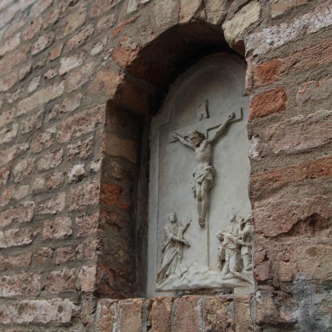 Stations of the Cross embedded in a brick wall
