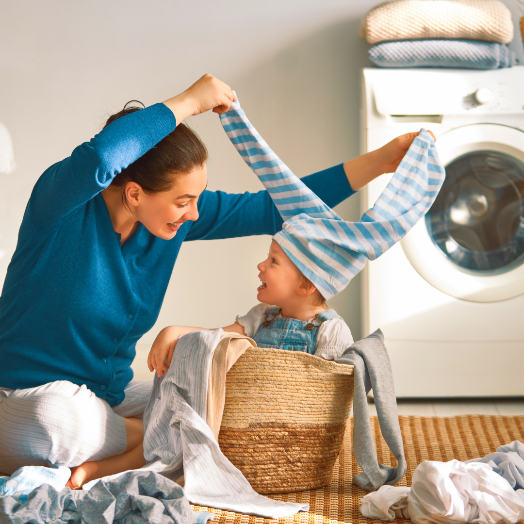 mom and child playing in laundry