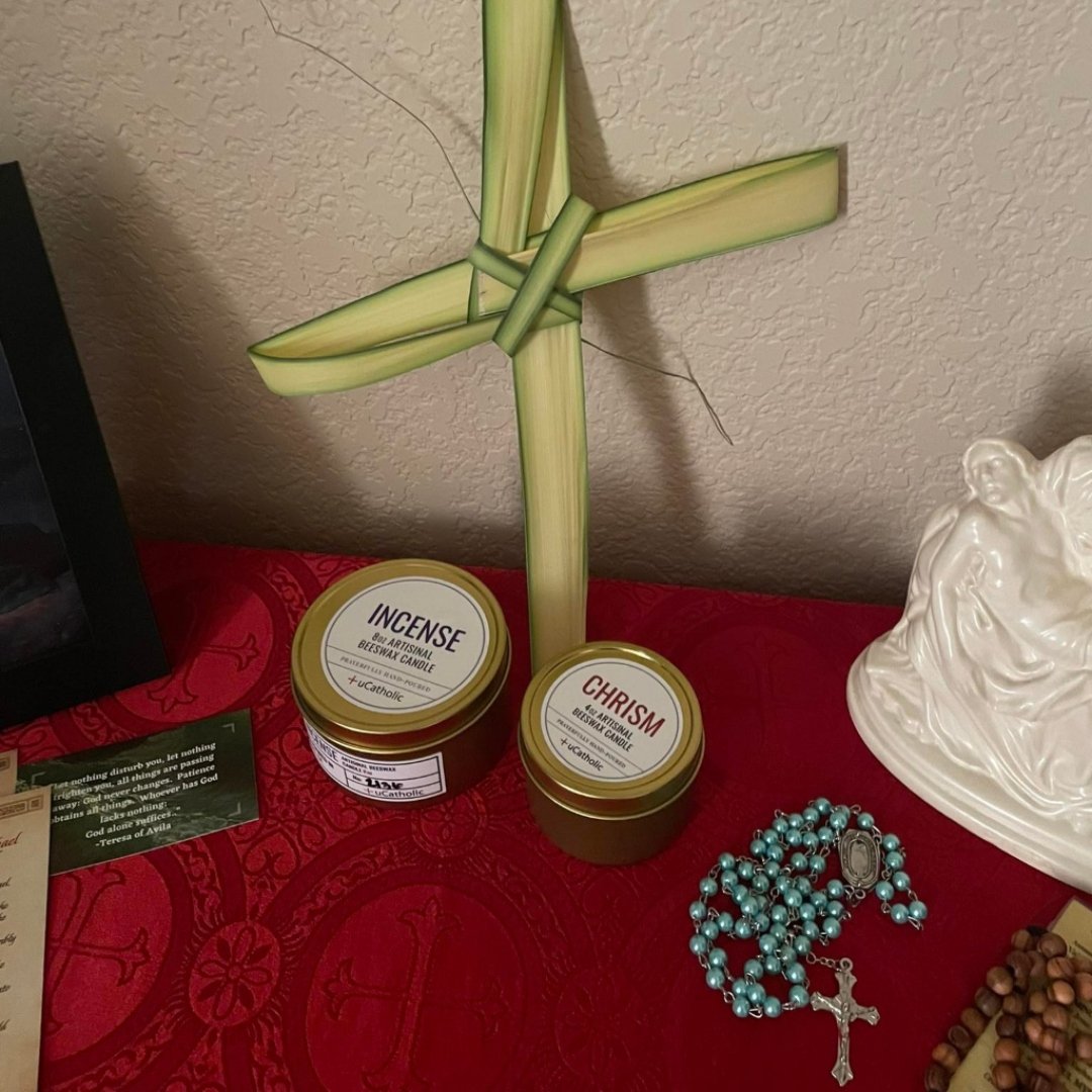 candles, palm cross, and rosary on prayer table
