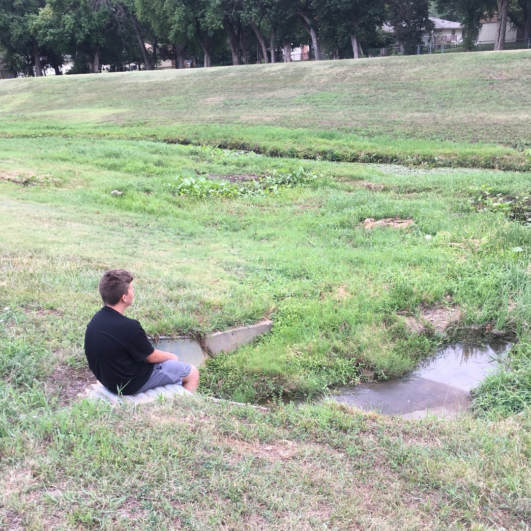 young man sitting in the grass