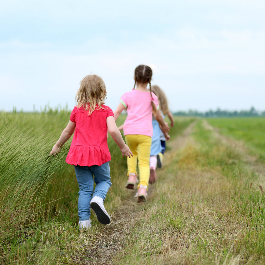children exploring a field