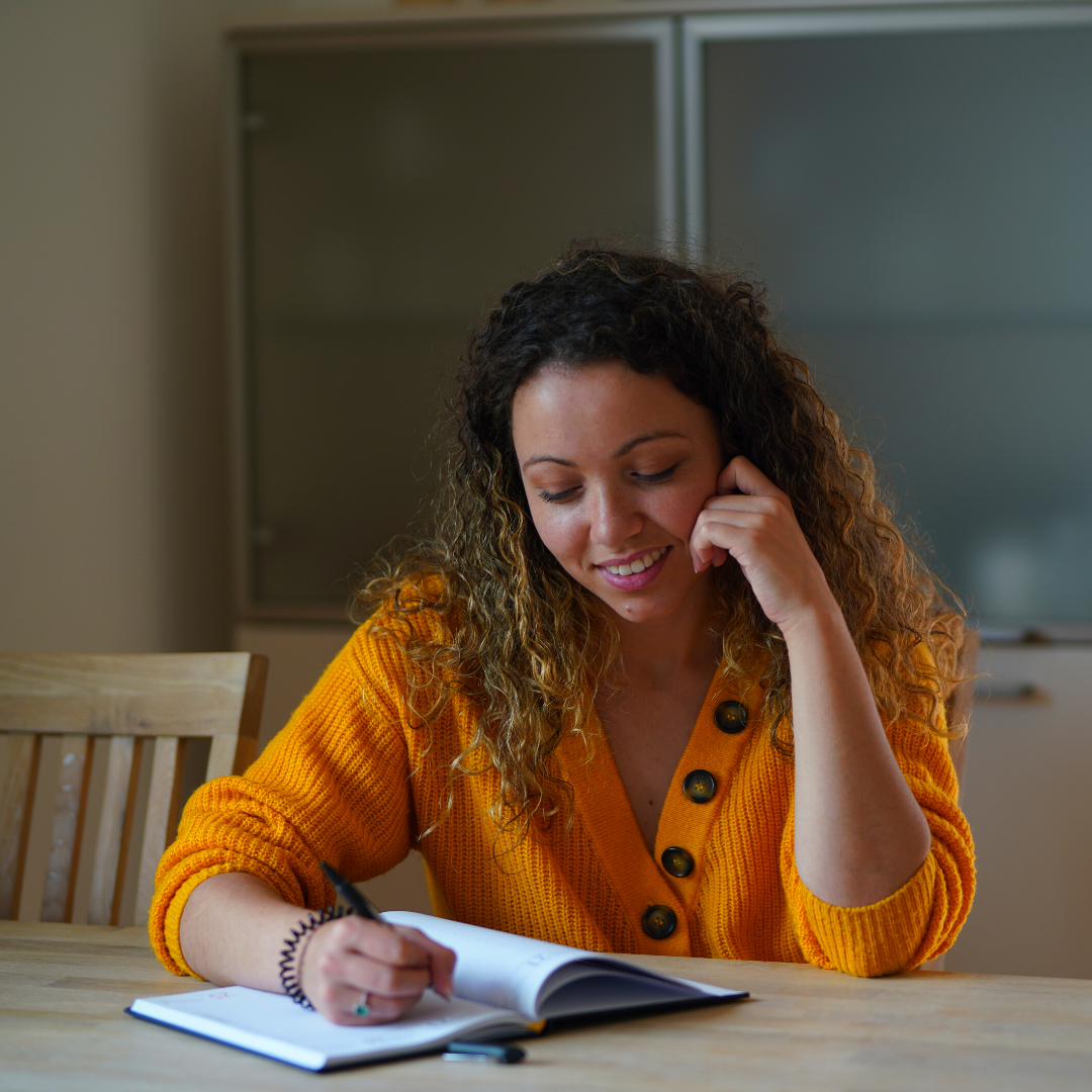 woman writing in a journal