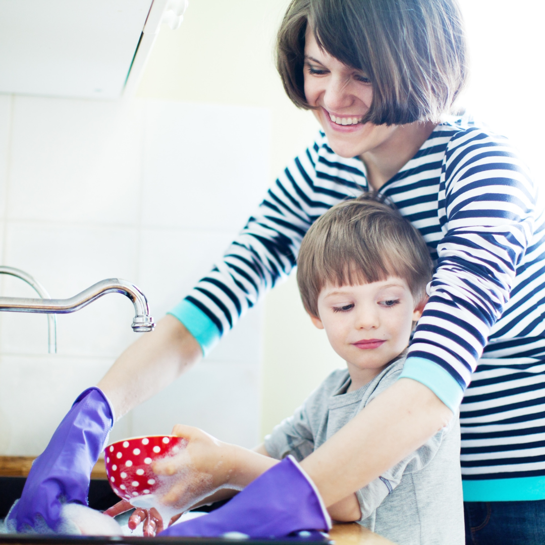 mom and little boy washing dishes