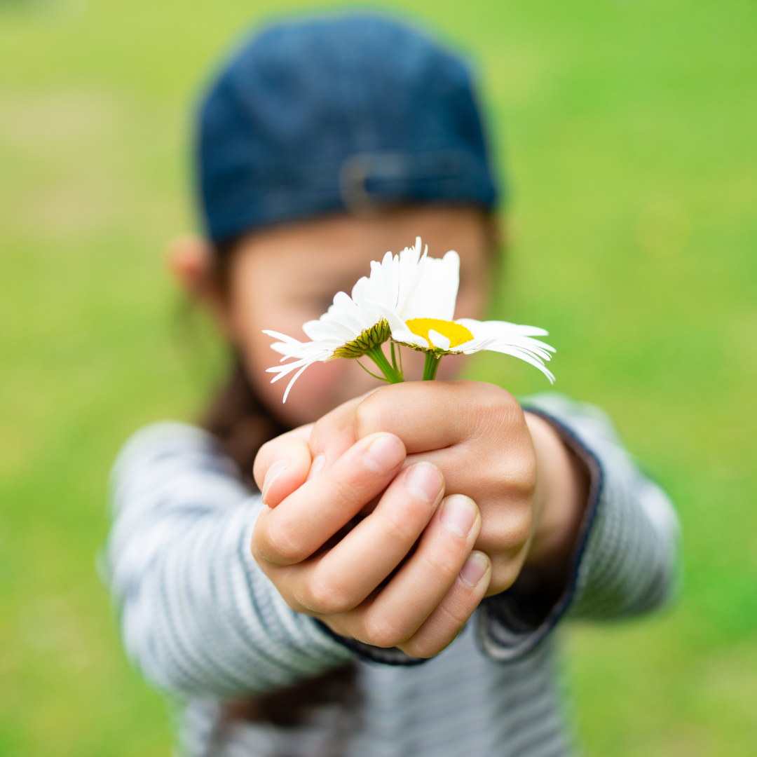 child offering flowers