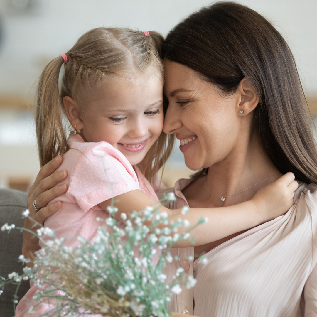 mom hugging little girl