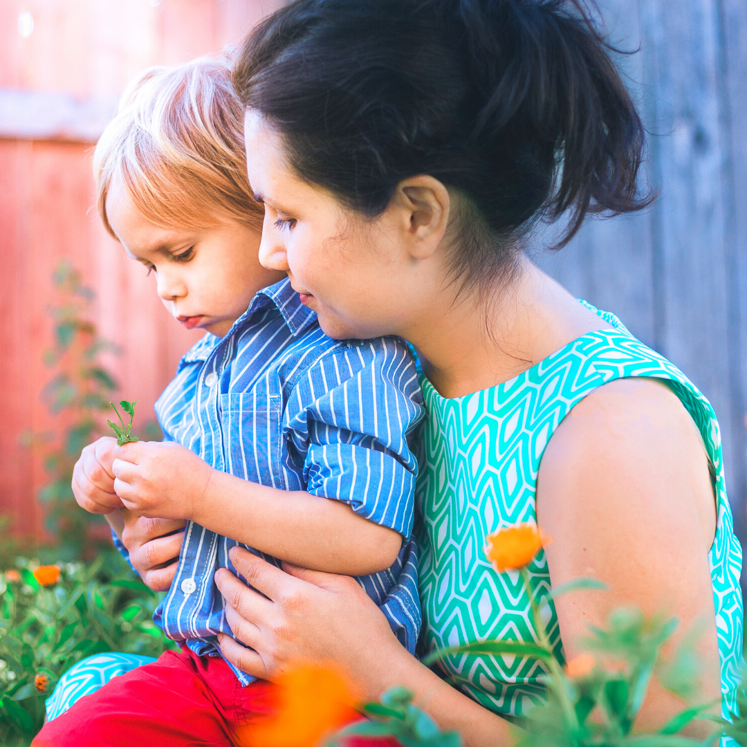mom and little boy in flower garden