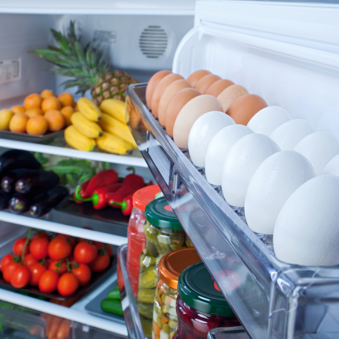 open refrigerator full of fresh produce and eggs