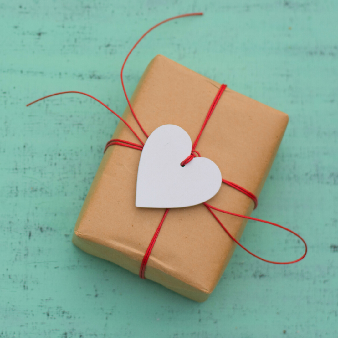 brown-wrapped gift with heart shaped tag