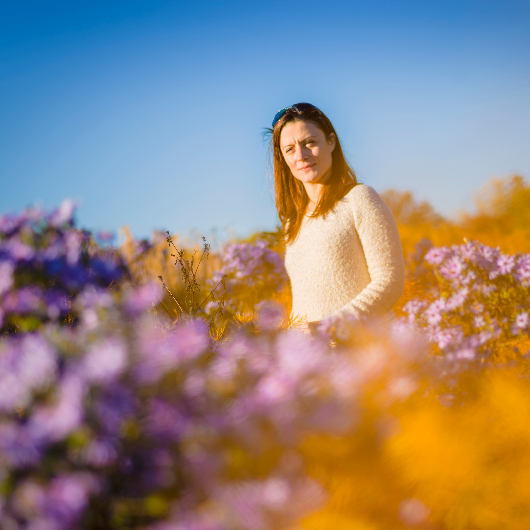 woman walking in field of purple flowers