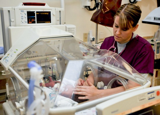 1280px-Flickr_-_Official_U.S._Navy_Imagery_-_A_nurse_examines_a_newborn_baby.
