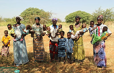 Yalgo, Burkina Faso, has a high rate of twin births—and malnutrition. These moms are thankful for the Blessed John Paul II Center, which provides nutritious food and well-baby checkups. Photo by Kim Pozniak/CRS