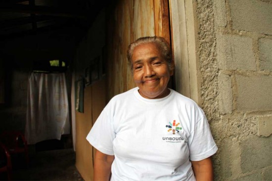 Beneranda stands in the doorway of her new home. Photo copyright 2015 Unbound. All rights reserved.