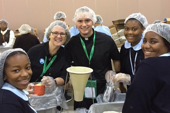 Lisa helps friends pack meals for Catholic Relief Services' "Helping Hands" program.