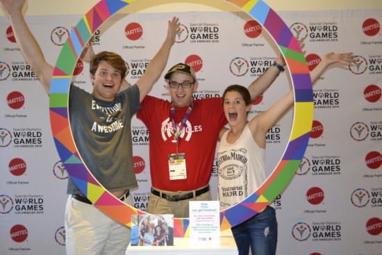 Daniel (center) reaches up for Special Olympics World Games Los Angeles 2015 in the Circle of Inclusion with his friends Sam (left) and Caroline (right) Shriver, grandchildren of Special Olympics founder Eunice Kennedy Shriver. Photo by Daniel Smrokowski/Special Chronicles.