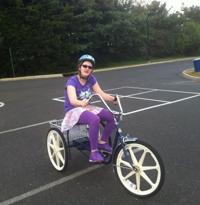 Danielle riding her grandmother's tricycle