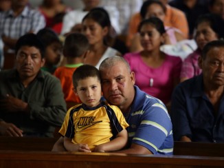 Sunday Mass at Olopa Municipality Church, Chiquimula state, Guatemala. This is nearest Church from cantón El Guayabo , hometown of the Ramírez family. The family subsists mainly on their agricultural activities. Their harvest goes mainly for the subsistence of the family. They plant corn, beans and vegetables for daily consumption. They also own land in which they cultivate coffee. The family was affected by the recent coffee leaf rust plague. Catholic Relief Services Guatemala has provided technical support to families, helping to maintain their food security and giving them new coffee management ideas with projects Green Coffee and “Puentes.” Silverlight for CRS