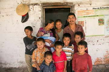 Cristina Garcia and her husband Porfirio Gomez Martinez, with their children and other family members. Photo by Phil Laubner/CRS