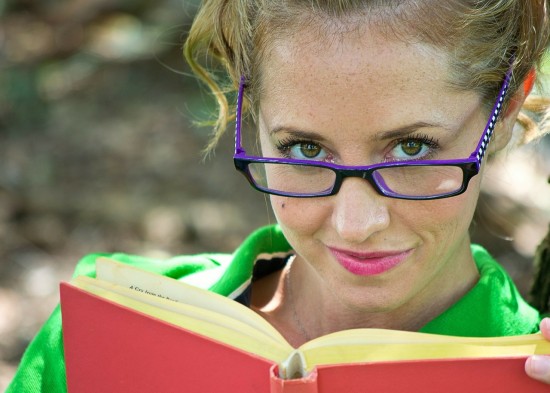 Girl with glasses reading book