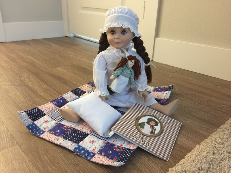 Laura comes in an eyelet ruffle-front nightgown and cap, an adorable rag doll, a pillow, patchwork quilt and a clever keepsake box that converts into a cozy bed which tucks in a log cabin backdrop, complete with window! 6 piece set makes an instant heirloom collection. High quality and unsurpassed detail - Laura features vinyl shoulders and a soft poseable body. Doll measures 18" high. Box measures 18 3/4"L X 7 1/4"W x 4 1/4"D. Sized for play with other 18" dolls and 18" doll accessories.