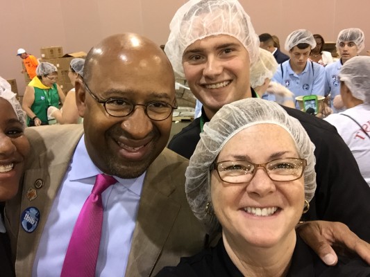 Philadelphia mayor Michael Nutter greets Lisa Hendey, a seminarian, and other volunteers at the Helping Hands event. Courtesy of Lisa Hendey. All rights reserved.