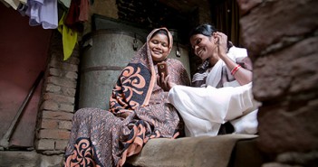 Sunita Devi, right, shares information—via a CRS-developed mobile phone app—that will help Sanchita, pregnant with her fourth child, deliver a healthy baby. The app prompts community health workers like Sunita to deliver specific messages based on the stage of pregnancy. Photo by Jennifer Hardy/CRS