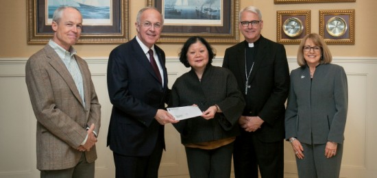 Carl A. Anderson (second from left), the Supreme Knight of the Knights of Columbus, presents a check for $500,000 to Dr. Carolyn Woo (center), the president & CEO of Catholic Relief Services. The generous donation will be used for Catholic Relief Services’ education programs for Syrian and Iraqi refugees living in Jordan. Also shown are Catholic Relief Services’ leadership (from left to right) Kevin Hartigan, regional director for Europe, the Middle East and Central Asia; Archbishop Paul S. Coakley of Oklahoma City and chairman of the Catholic Relief Services board; and Joan Rosenhauer, executive vice president of U.S. Operations. Photo courtesy of the Knights of Columbus