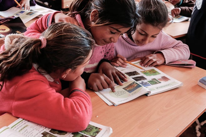 Students, from left, Zainab, 10, and Ola and Evine, 12, attend science class at the Good Shepherd Sisters center. These refugees fled Syria's Idlib and Aleppo provinces for Lebanon, where the winter has been harsh. Besides schooling, the sisters provide children with winter clothes and meet other critical needs. Photo by Sam Tarling for CRS