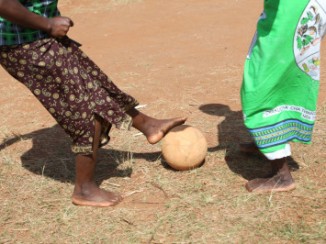 Members of a WALA care support group play soccer outside the community center in their village Tholo, Malawi. The group uses soccer as a fun way to promote key messages about health, hygiene and nutrition to the greater community. Photo by Sara A. Fajardo/CRS