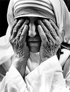 Mother Teresa takes a moment to shield her eyes with the hands she has used to hold so many people in need. Photo by Kent Kobersteen/CRS