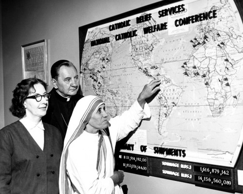 Mother Teresa is joined by longtime CRS staffer Eileen Egan and former CRS Executive Director Bishop Edward Swanstrom as they plan overseas food shipments. Photo by CRS staff