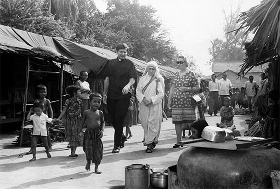 Mother Teresa joins CRS on a visit to Cambodia amidst a refugee crisis in 1968. She is flanked by CRS’ Father Robert Charlebois and Julie Villaume. Photo by CRS staff