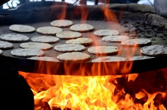 Maize tortillas cook on a roaster at a roadside cafe in El Salvador. Photo by Neil Palmer for CIAT