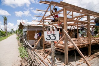 Construction on a CRS-designed home. When Typhoon Haiyan devastated the Visayas in central Philippines in November 2013, families on the eastern side of Leyte island were hit particularly hard as their homes and livelihoods were destroyed. CRS is helping families with individual approaches to transitional shelter. For some, this means staggered cash grants to repair or rebuild homes, with subsequent payments conditional on agreed-upon construction progress. Other families are receiving shelters designed by CRS engineers to meet the needs of their particular location. Low-lying areas, for example, need raised houses to avoid periodic flooding, while other houses are designed with a mix of cement block and wood or woven walls. By using an approach that can be personalized for each family, CRS can address individual needs and preferences. It also considers the complex land title situation in typhoon-affected areas. Some families own their land, others rent and still others were living on land without permission from the owner. The flexibility of this shelter project allows CRS to serve a cross section of the population, not just those with a land title. Keywords: Haiyan, typhoon, shelter, transitional shelter Project funded by DFAT (formerly Australian Aid).