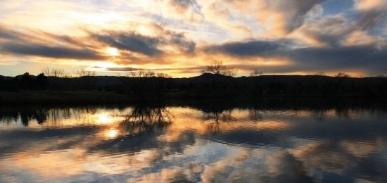 Sunset reflected in water of lake (24 November 2011) from commons.wikimedia.org; public domain.