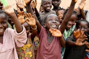 Villagers in the remote village of Joi, Sierra Leone. There a CRS-led savings-and-loan program has brought each household enough money to build a tin roof for each house. Philip Laubner/CRS