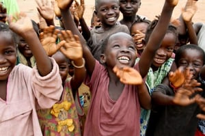 Villagers in the remote village of Joi, Sierra Leone.  There a CRS-led savings-and-loan program has brought each household enough money to build a tin roof for each house.  Philip Laubner/CRS