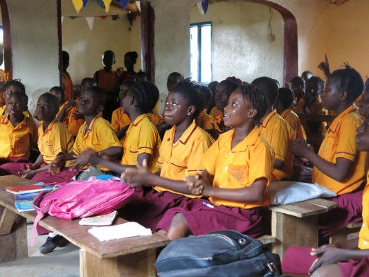 Children participate in an interactive session to help them cope with the trauma and loss of  the Ebola epidemic in Sierra Leone. Support for orphans is part of CRS' response. Photo by Annisha Vasutavan/CRS