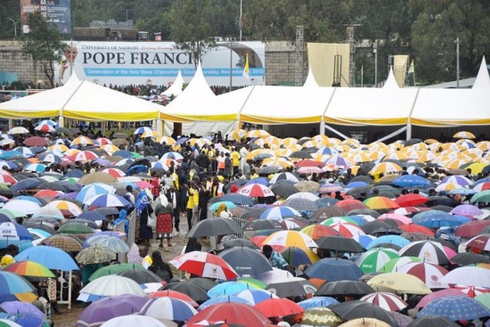 Kenyans stand in the rain to hear Pope Francis at the University of Nairobi.