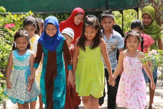 Sponsored children in the southern Philippines play together. Unbound promotes peace and harmony in the region through activities with children and families.