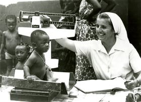 Benin, 1981 - Sr. Marot weighs children at a clinic in Benin. Photo from the CRS archives
