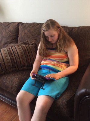Danielle with her augmentative communication machine called a NovaChat.
