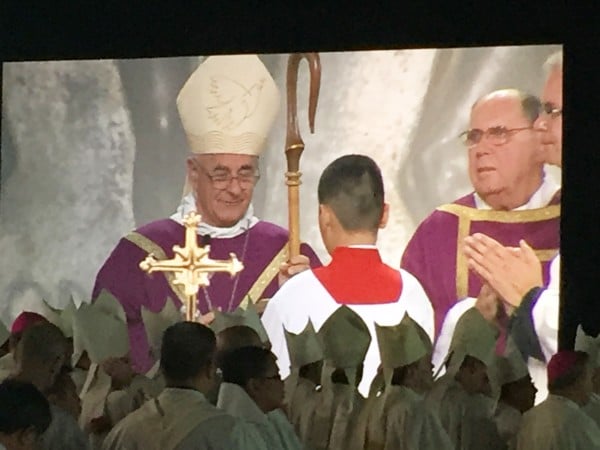 Archbishop Vincenzo Paglia, president of the pontifical council for the family celebrates Mass, while a mass of clergy from around the world sit attentive on the stage near him. Copyright 2015 Roxane Salonen. All rights reserved.