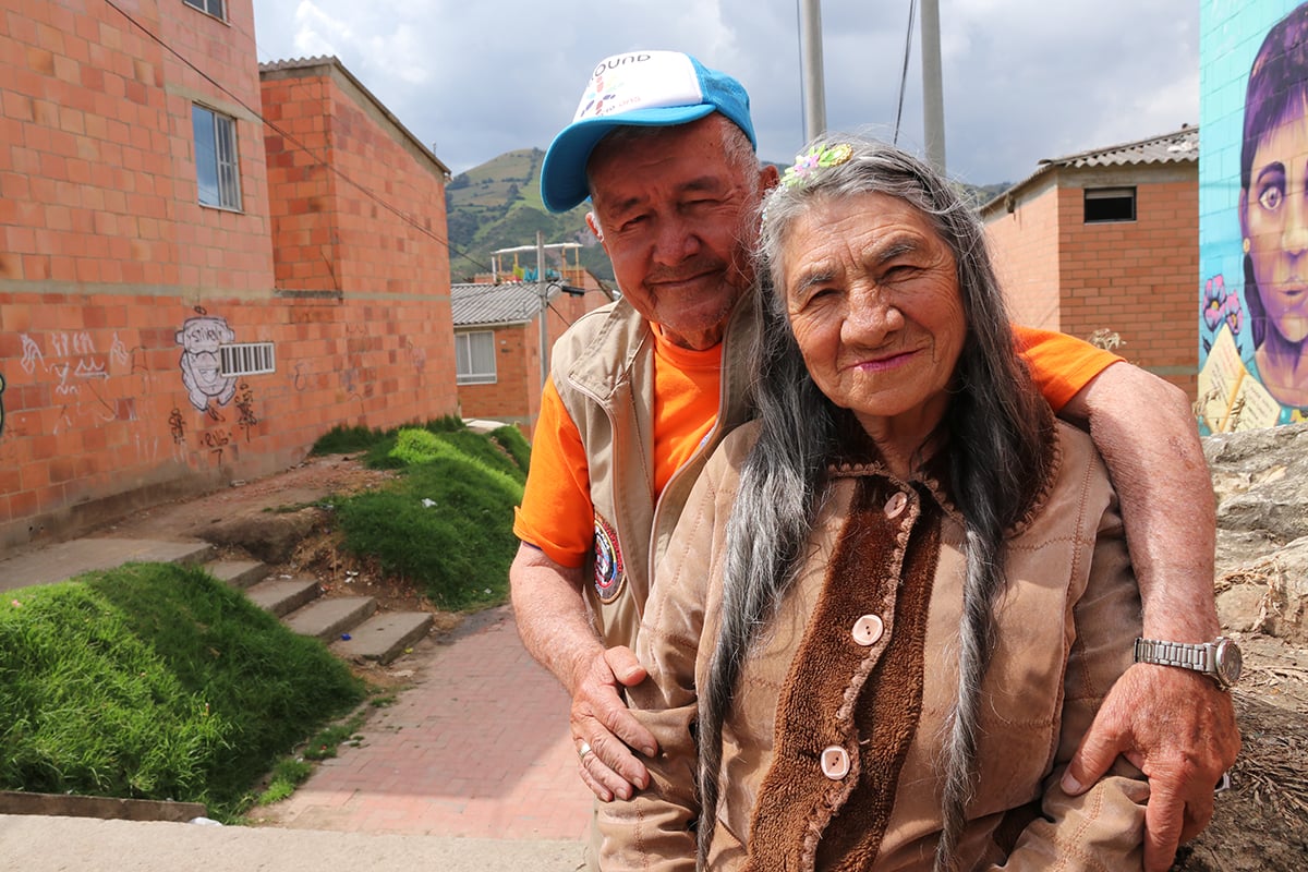 Man wearing hat with logo for Unbound, with his wife, in Colombia